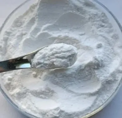 Fine white powder in a glass dish with a metal spatula